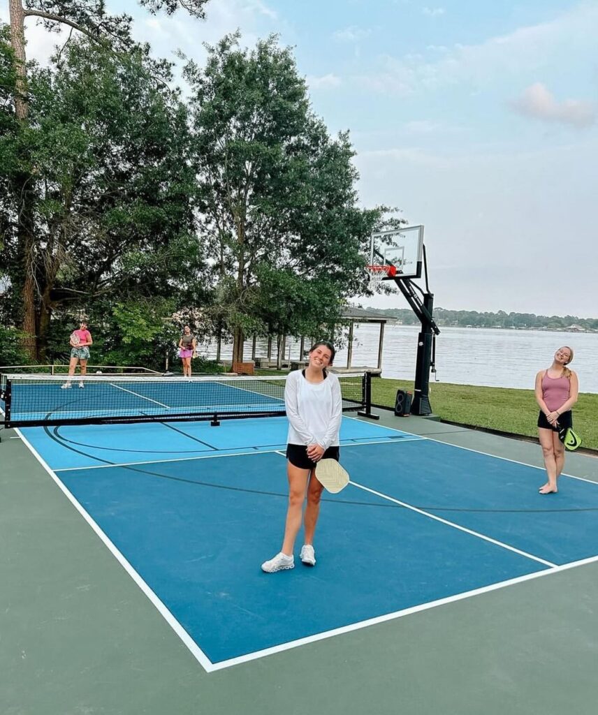 Family playing on a backyard pickleball court in Houston — fun, active outdoor living in a custom residential setup.