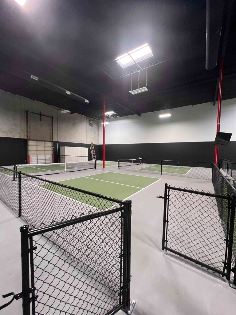 A spacious indoor facility in Houston featuring 24 newly constructed indoor pickleball courts with professional lighting, nets, and court painting.