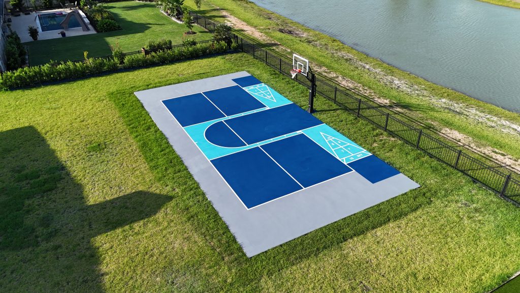 Custom multi-court in Sante Fe, Texas featuring half-court basketball with hoop, pickleball, and shuffleboard in blue, sky blue, and grey color scheme.