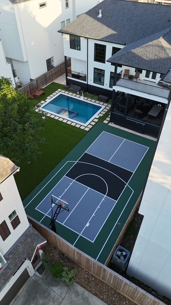 Backyard multi-sport court with basketball hoop and pickleball lines in a Houston residential yard