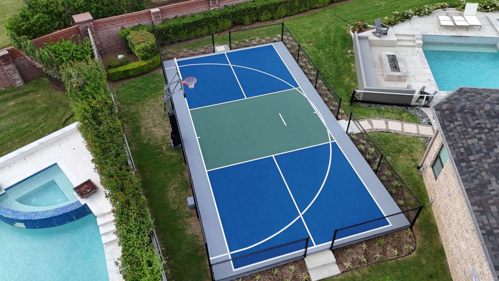 Sugar Land TX multi sport court with basketball hoop, rollaway pickleball net, and custom blue, green, gray surfacing with white lines