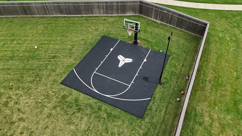 Black mini basketball court with white lines and custom Kobe Bryant logo