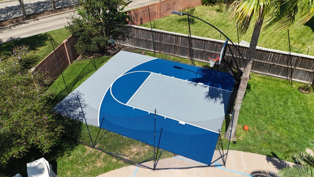 Outdoor basketball court installed in Houston with pro hoop, 25x25 size, blue and gray surface
