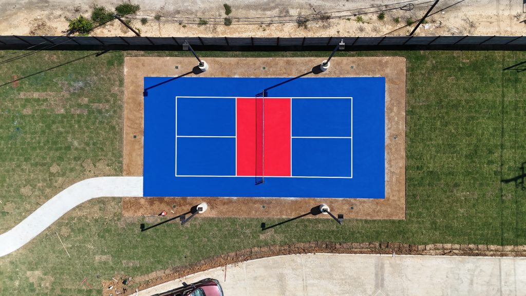Custom pickleball court in Houston finished with blue and red surfacing