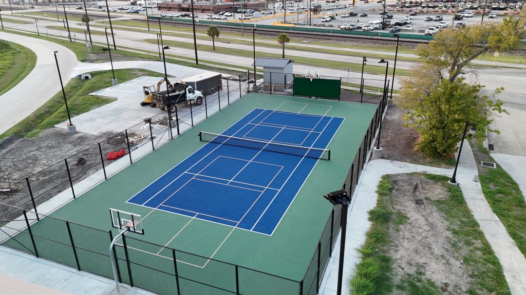 Newly built multi-sport court at Morgon's Point, La Porte, Texas, featuring tennis and basketball surfaces