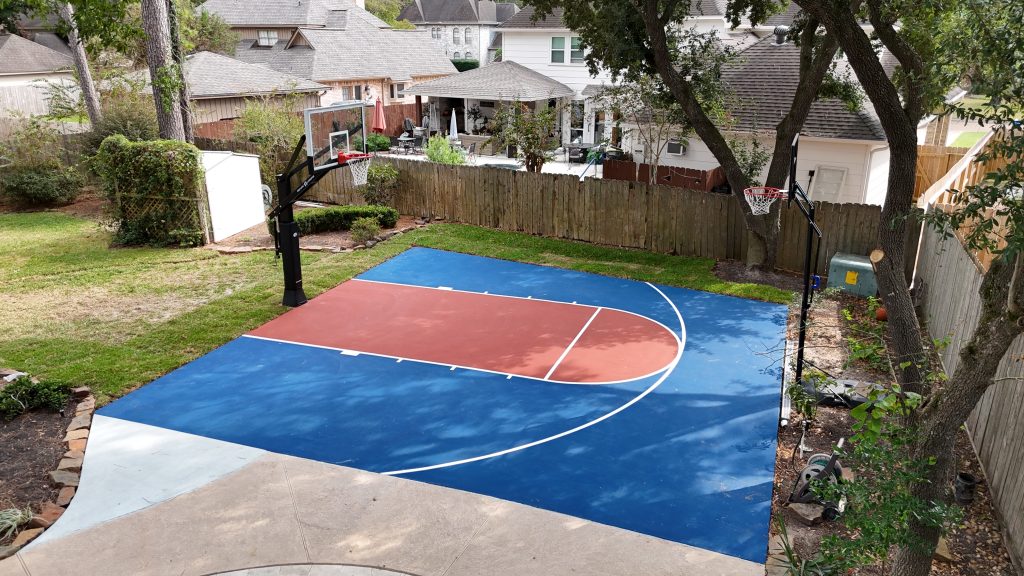 Custom backyard mini basketball court surface with red and blue colorway Kingwood Texas