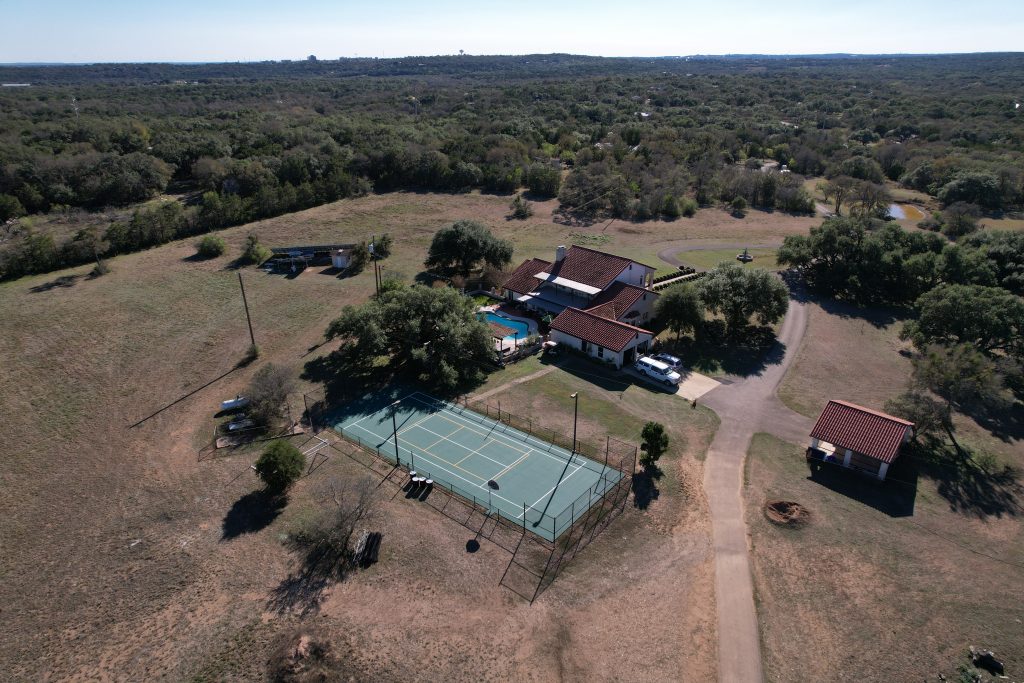 Resurfaced backyard tennis court with pickleball striping