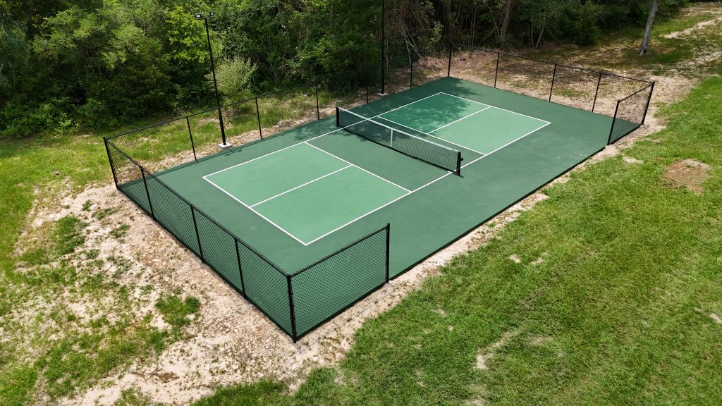 Lighted green pickleball court with fencing constructed by Build My Courts in Houston