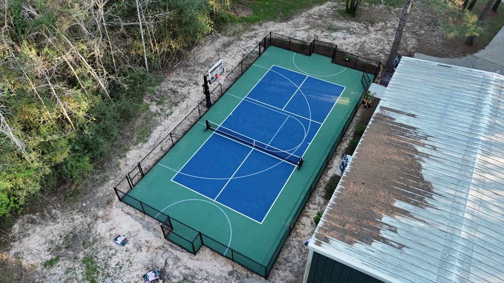 blue backyard multi sport court Montgomery Texas with basketball and pickleball lines