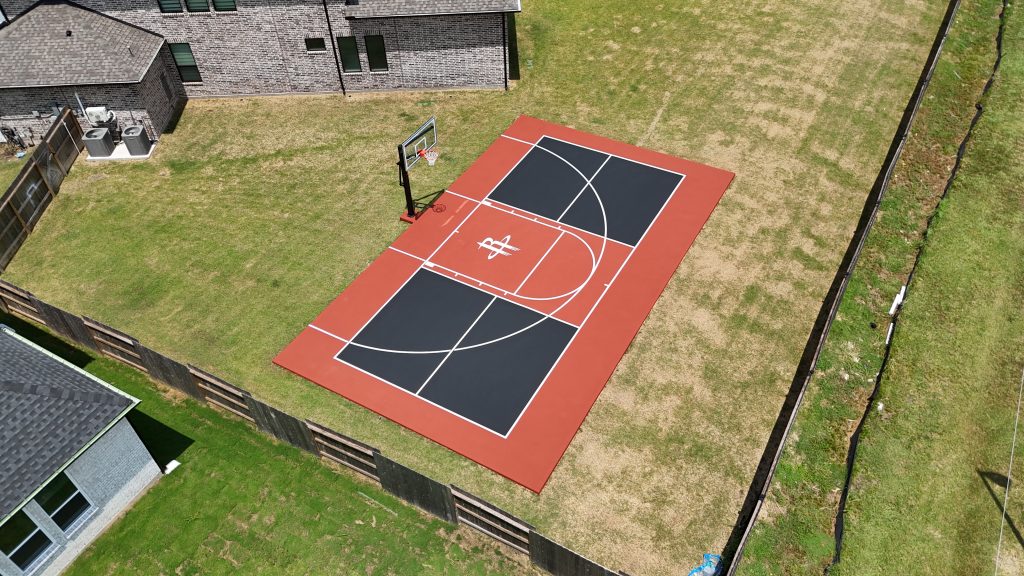 Custom multi-sport basketball and pickleball court in a residential backyard.